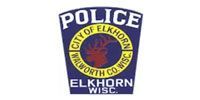 Elkhorn, Wisconsin Police Department badge. Blue, white and gold seal with red deer silhouette.