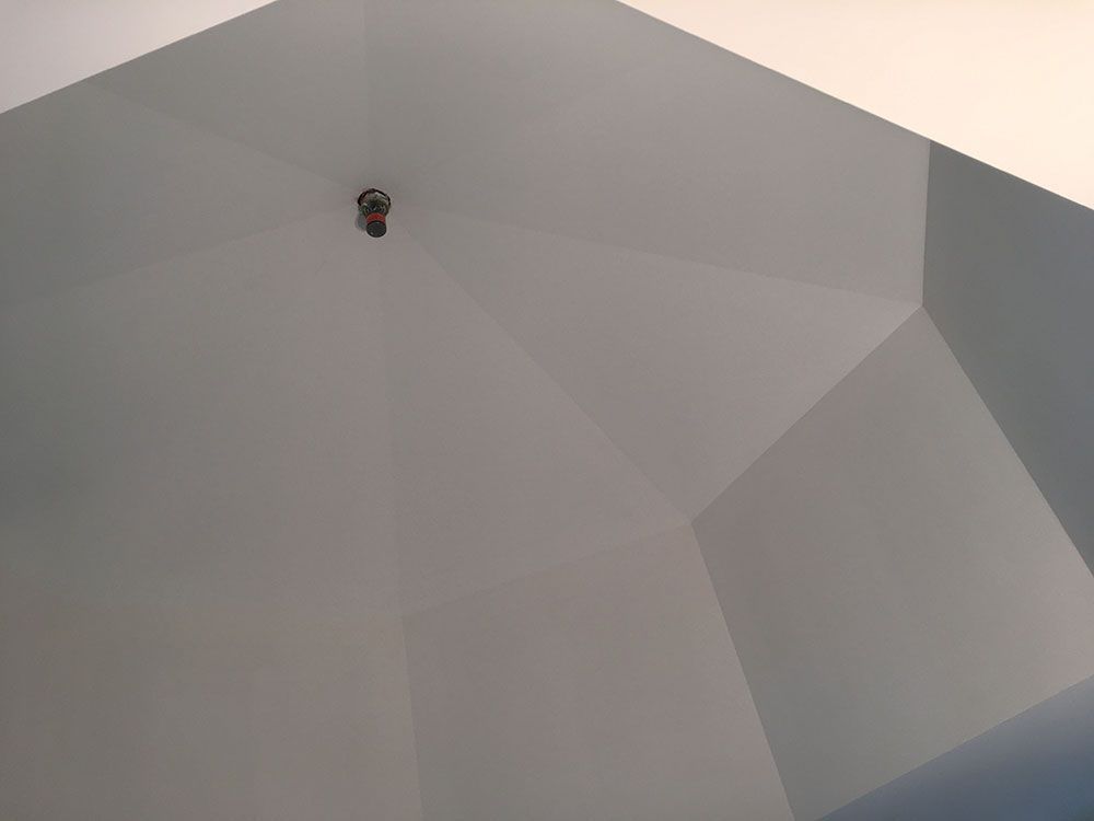 A light bulb is hanging from the ceiling of a room