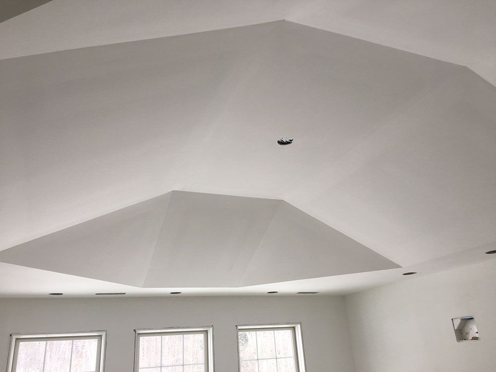 A room with a white ceiling and a lot of windows