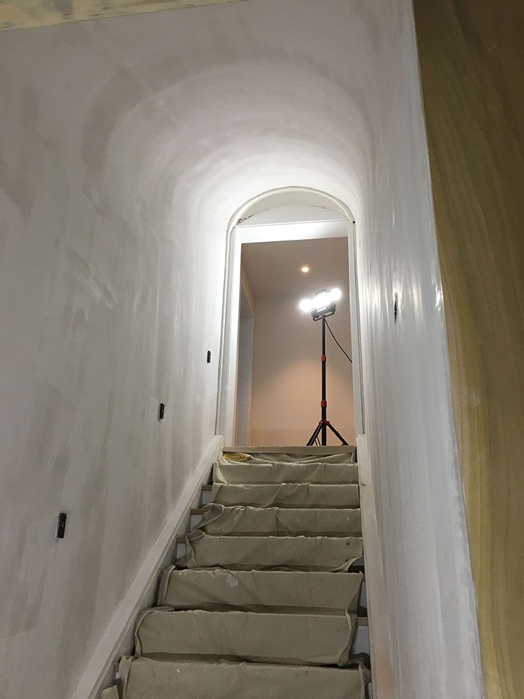 A set of stairs leading up to a tunnel in a building.