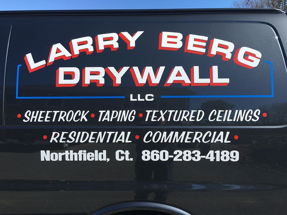 A black van with larry berg drywall written on it