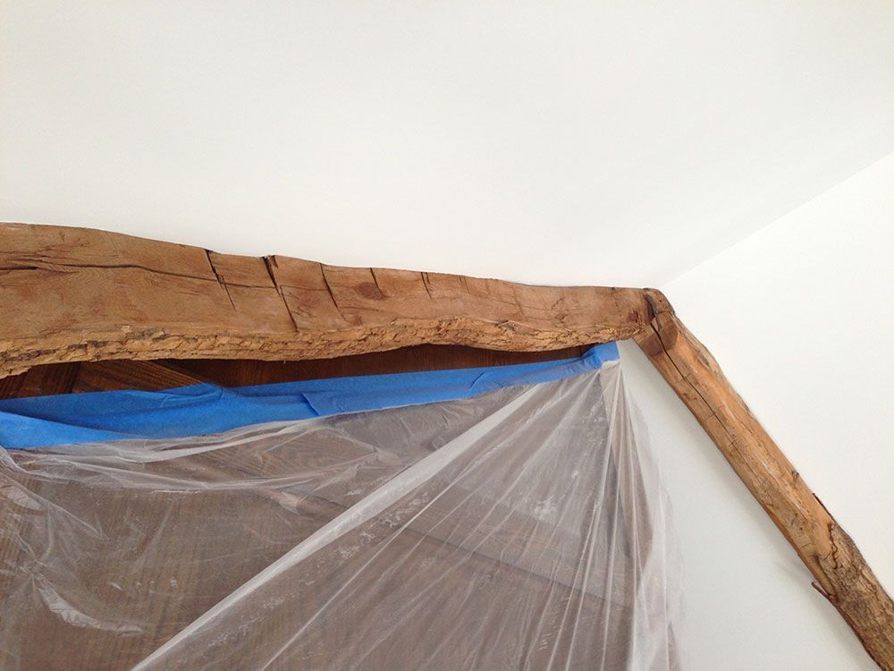 A piece of wood is covered in plastic and blue tape