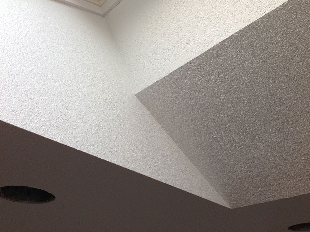 Looking up at a white ceiling with a skylight