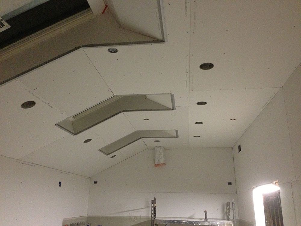 A room with a ceiling that has a few holes in it