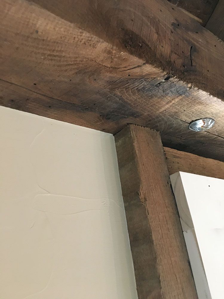 A close up of a wooden ceiling with a light on it.