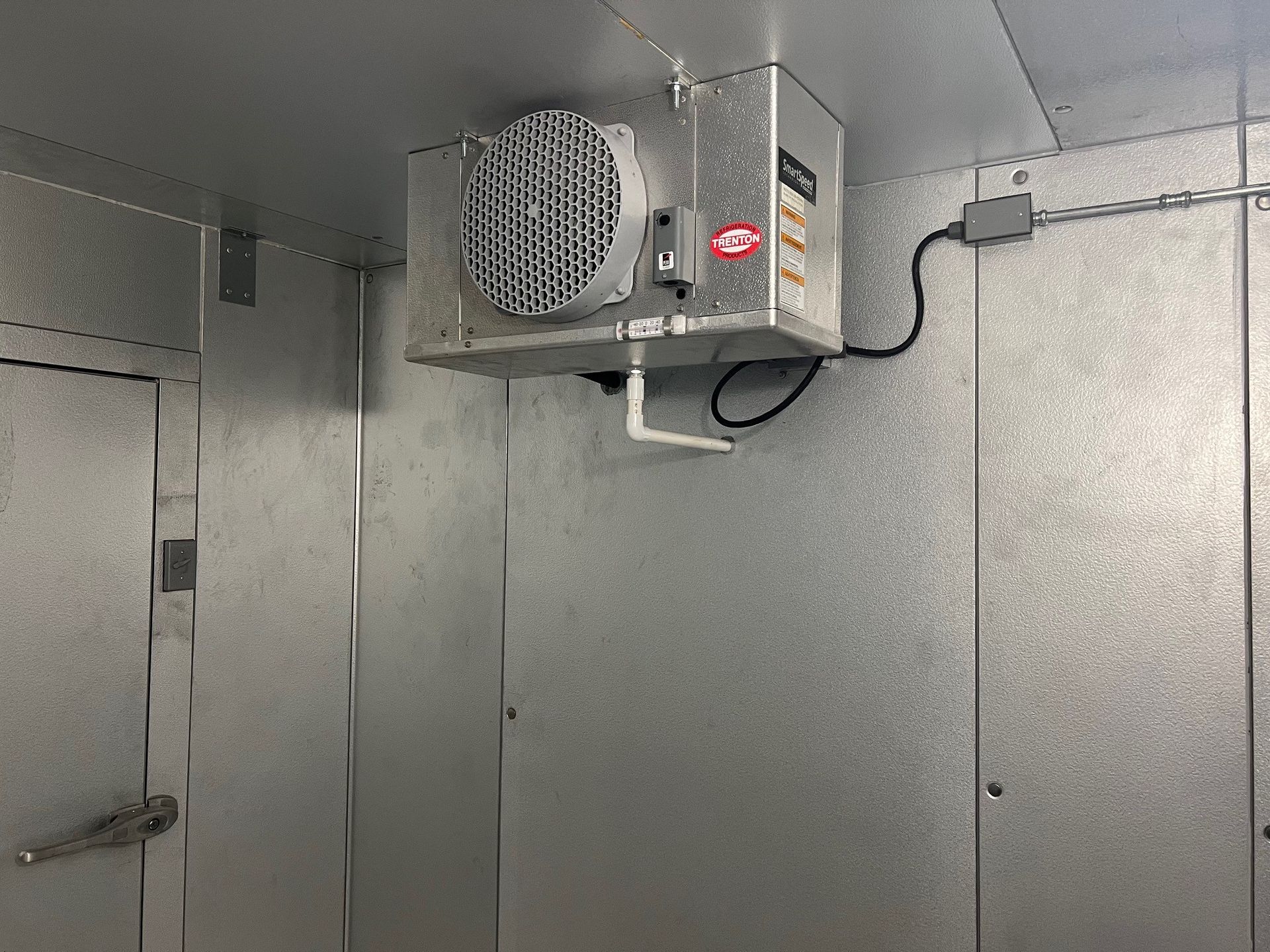 there is a fan hanging from the ceiling of a room .