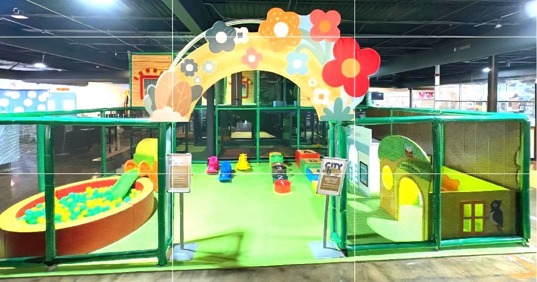 Indoor children's play area with a green and yellow theme.