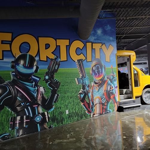 There is a large mural on the wall that says fort city.