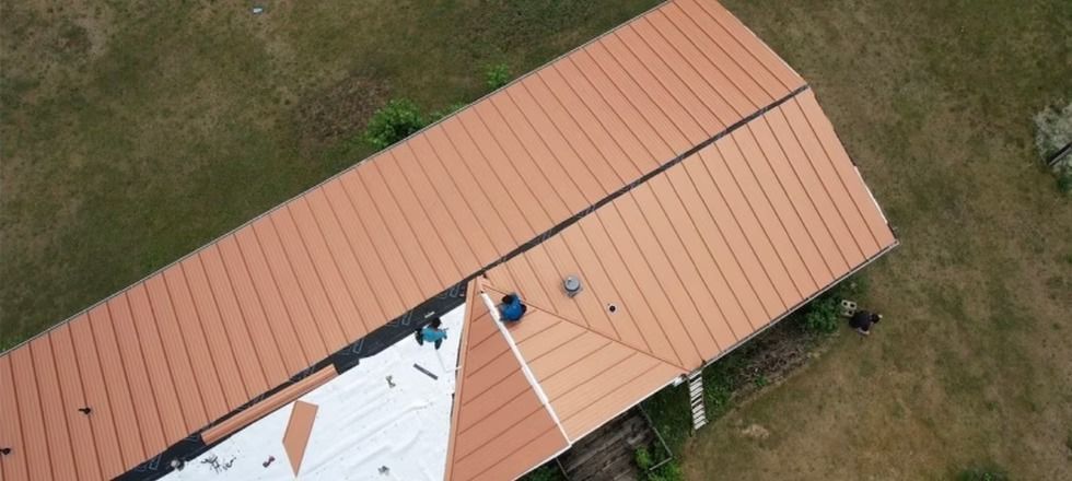 An aerial view of a house with a roof being installed.