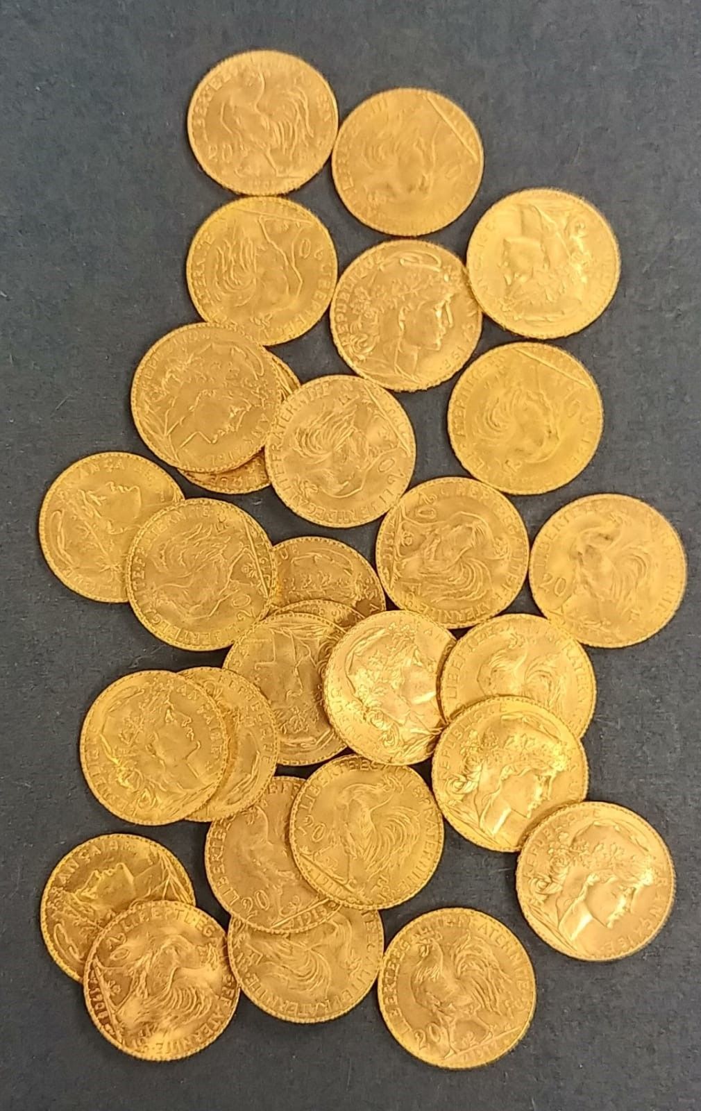 A pile of gold coins on a black surface