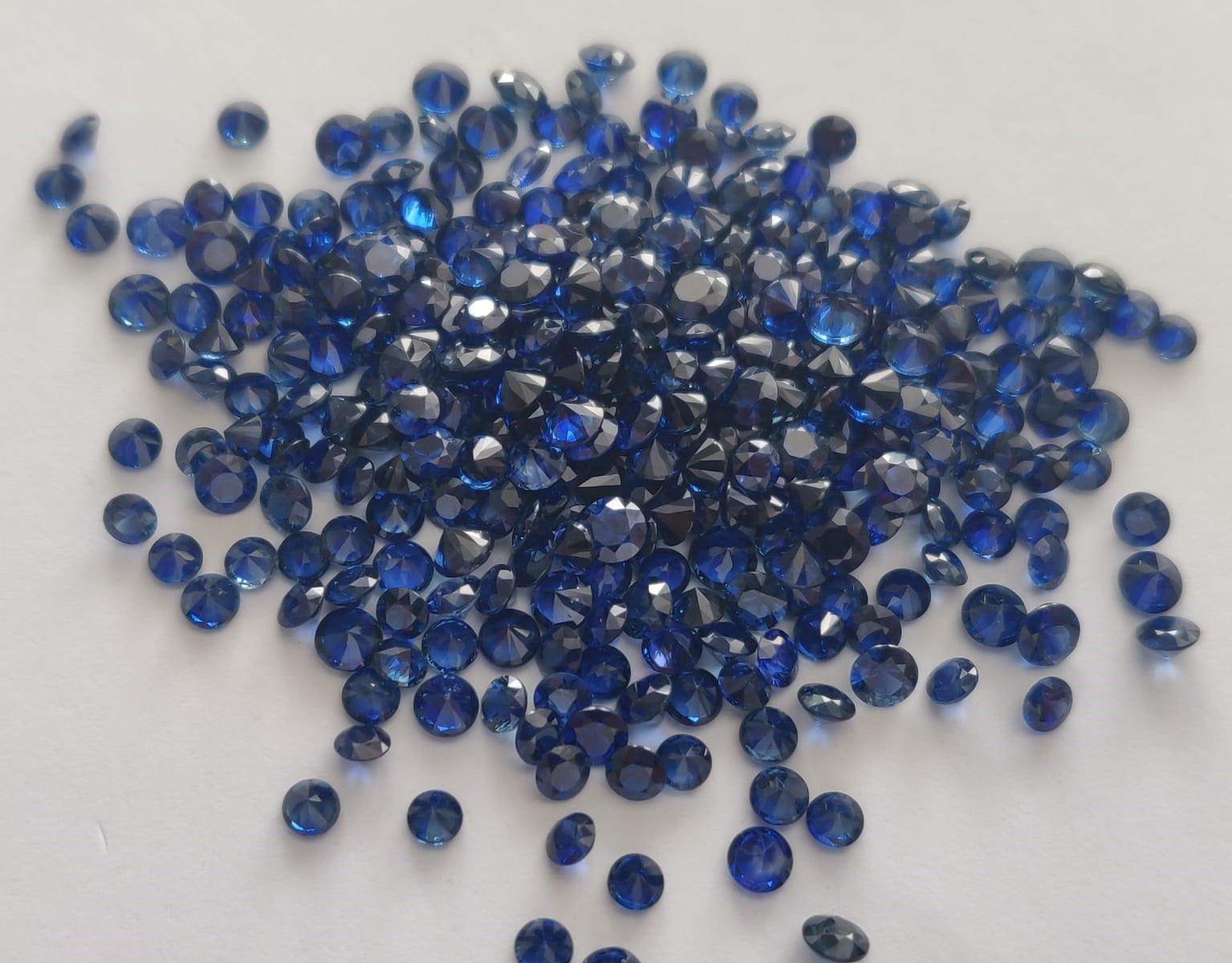 A pile of blue stones on a white surface