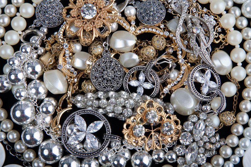 A pile of pearls and rhinestones on a black background