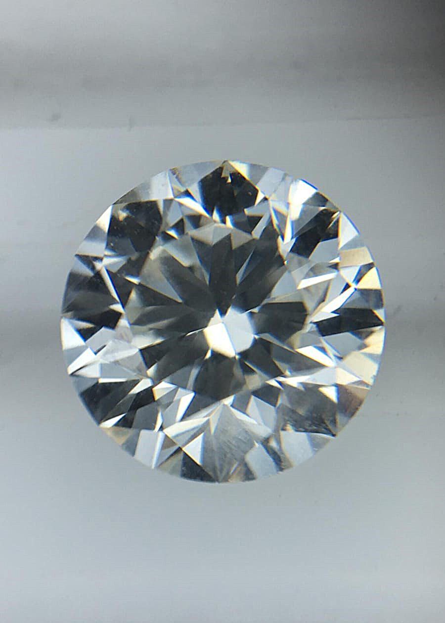 A close up of a diamond on a white surface