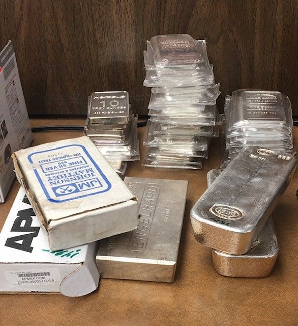 A stack of silver bars sitting on top of a table