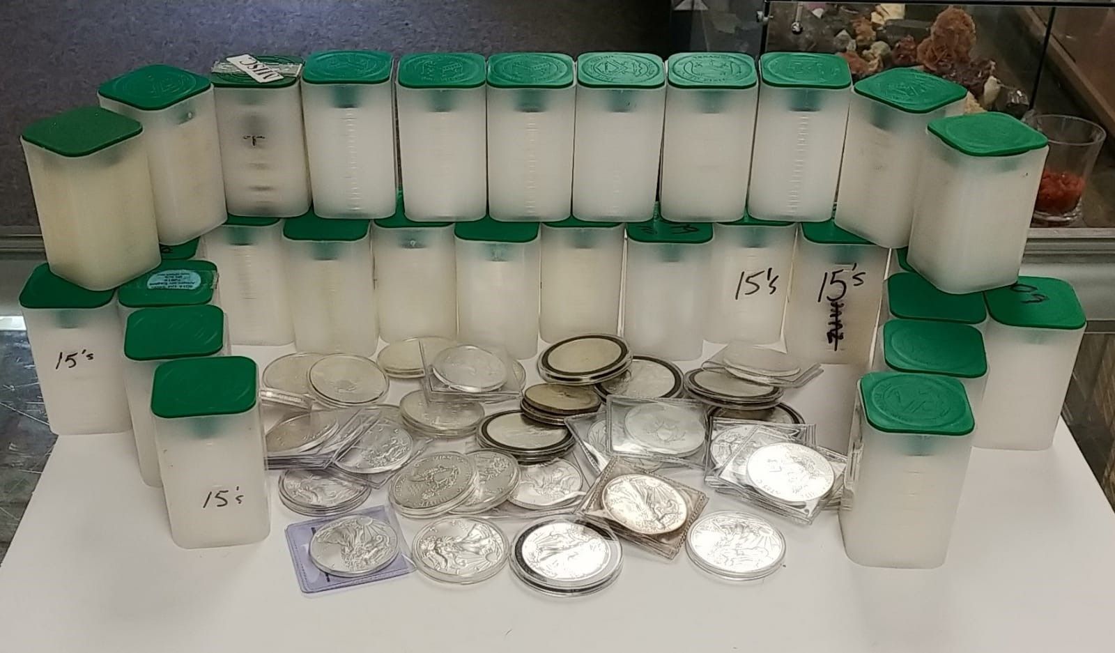 A bunch of silver coins are stacked on top of each other on a table.