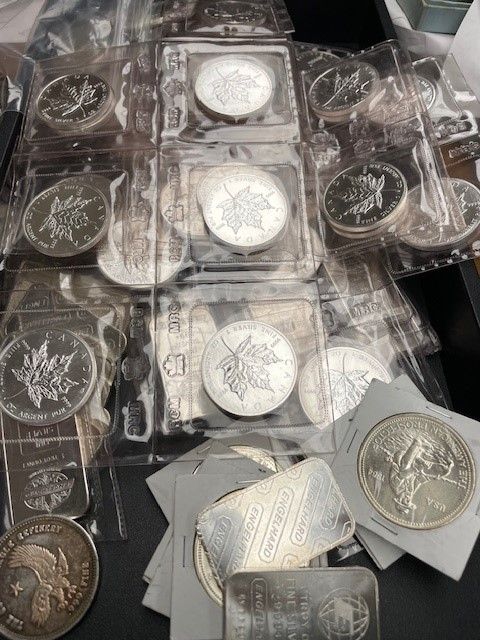 A bunch of silver coins are stacked on top of each other