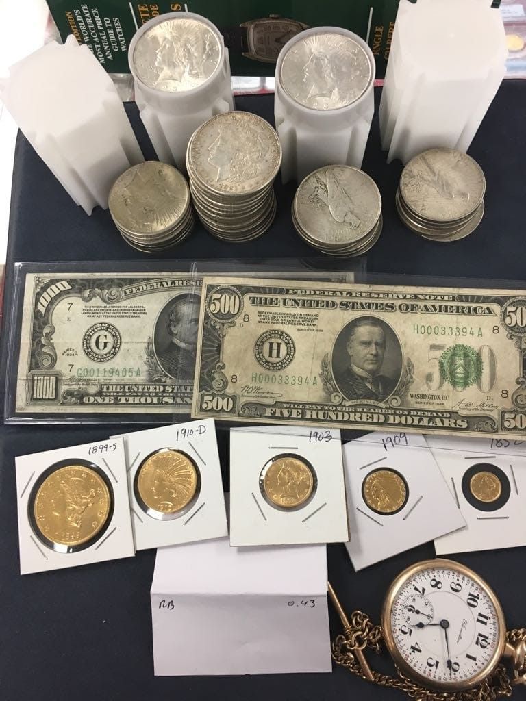 A bunch of coins and a dollar bill on a table