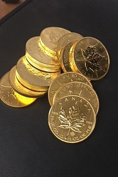 A pile of canadian gold coins on a table