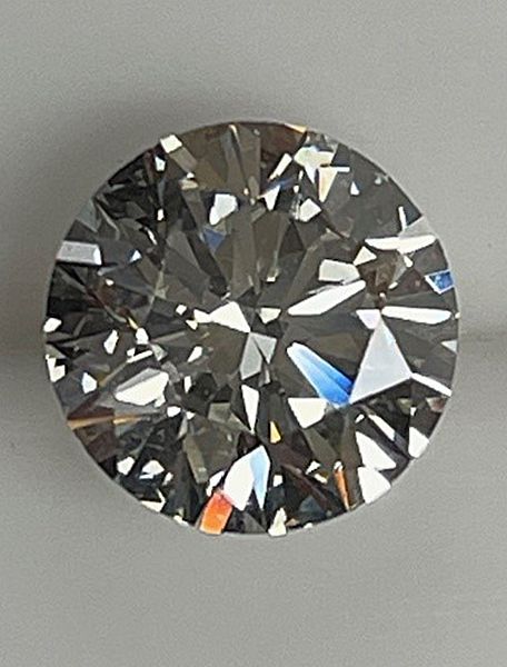 A close up of a round diamond on a table