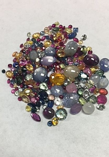 A pile of colorful stones on a white surface