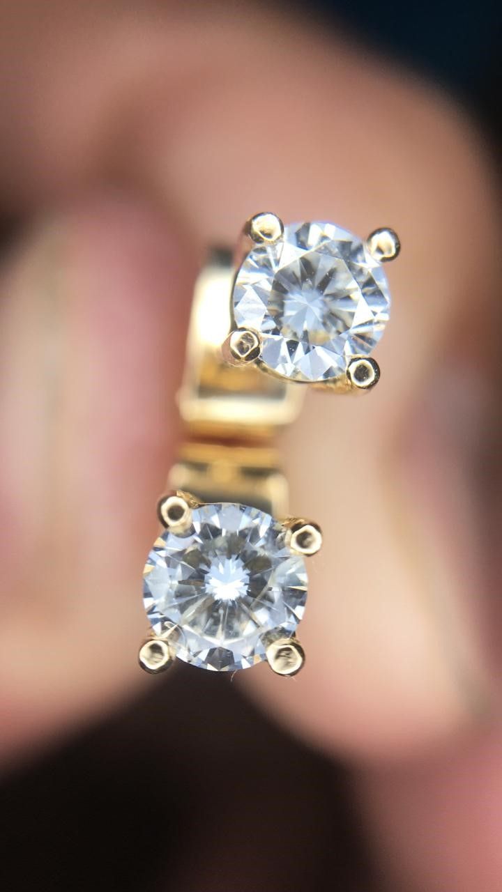 A close up of a ring with two diamonds on it