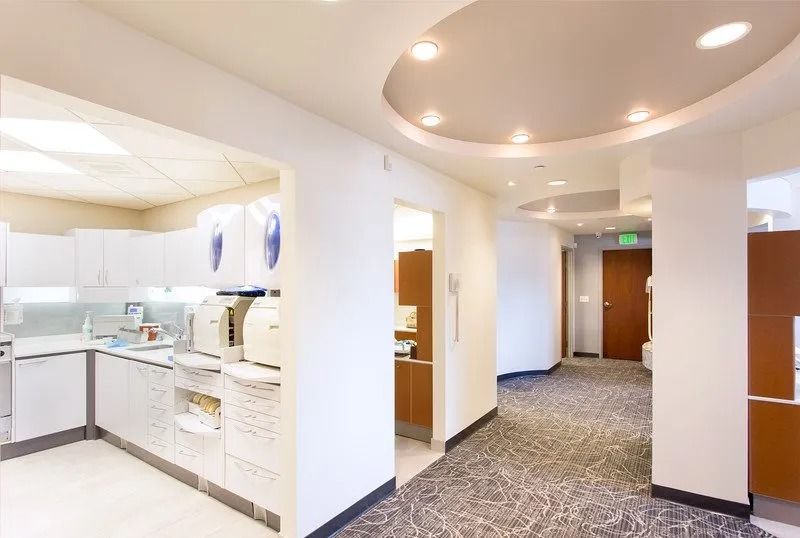 A hallway in a dental office with a ceiling light.