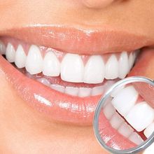 A woman 's teeth are being examined by a dental mirror