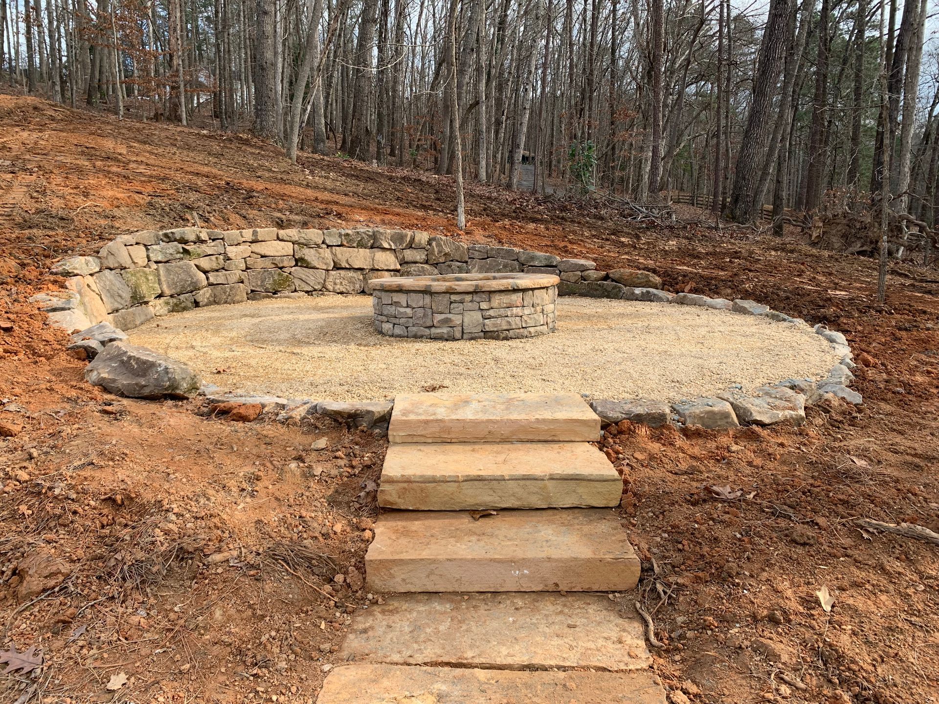A patio with rocking chairs and vases in front of a house.