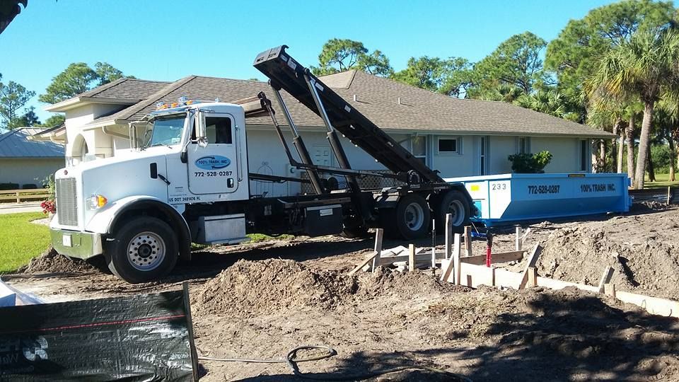 A dump truck is parked in front of a house