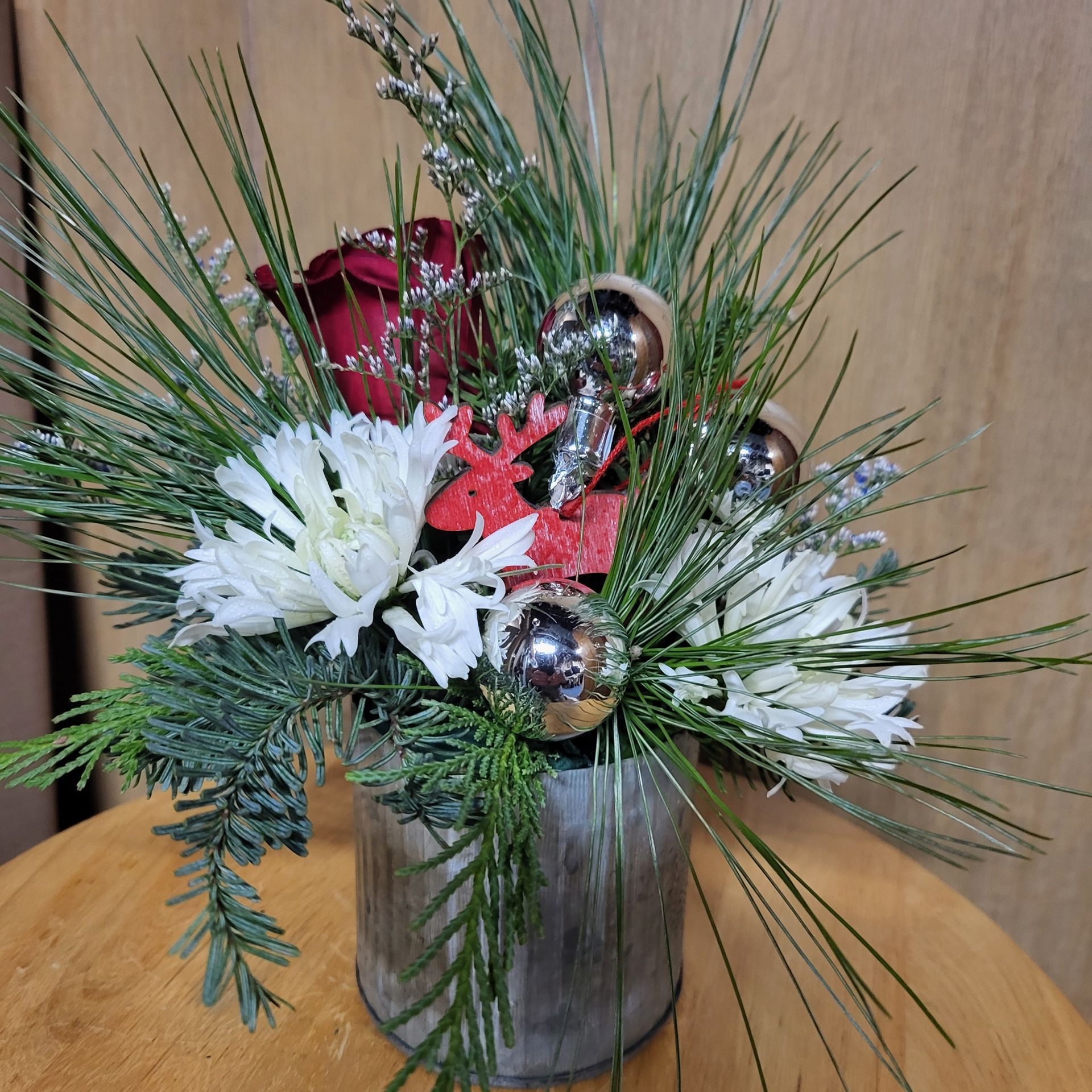 A vase filled with flowers is sitting on a table.