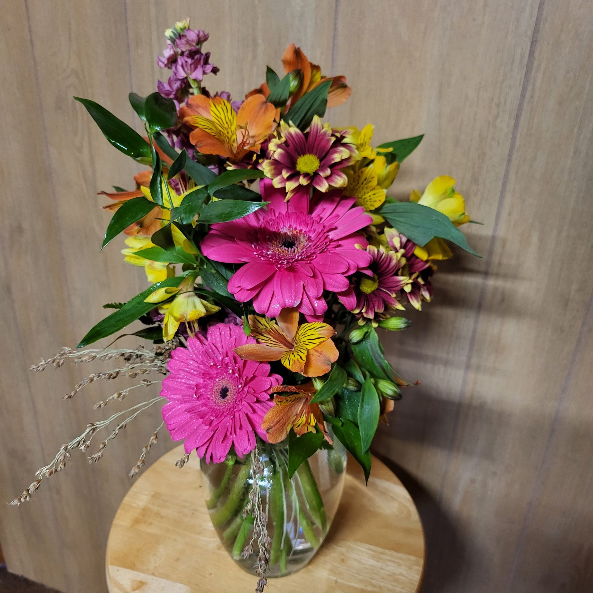 A vase filled with flowers is sitting on a table.