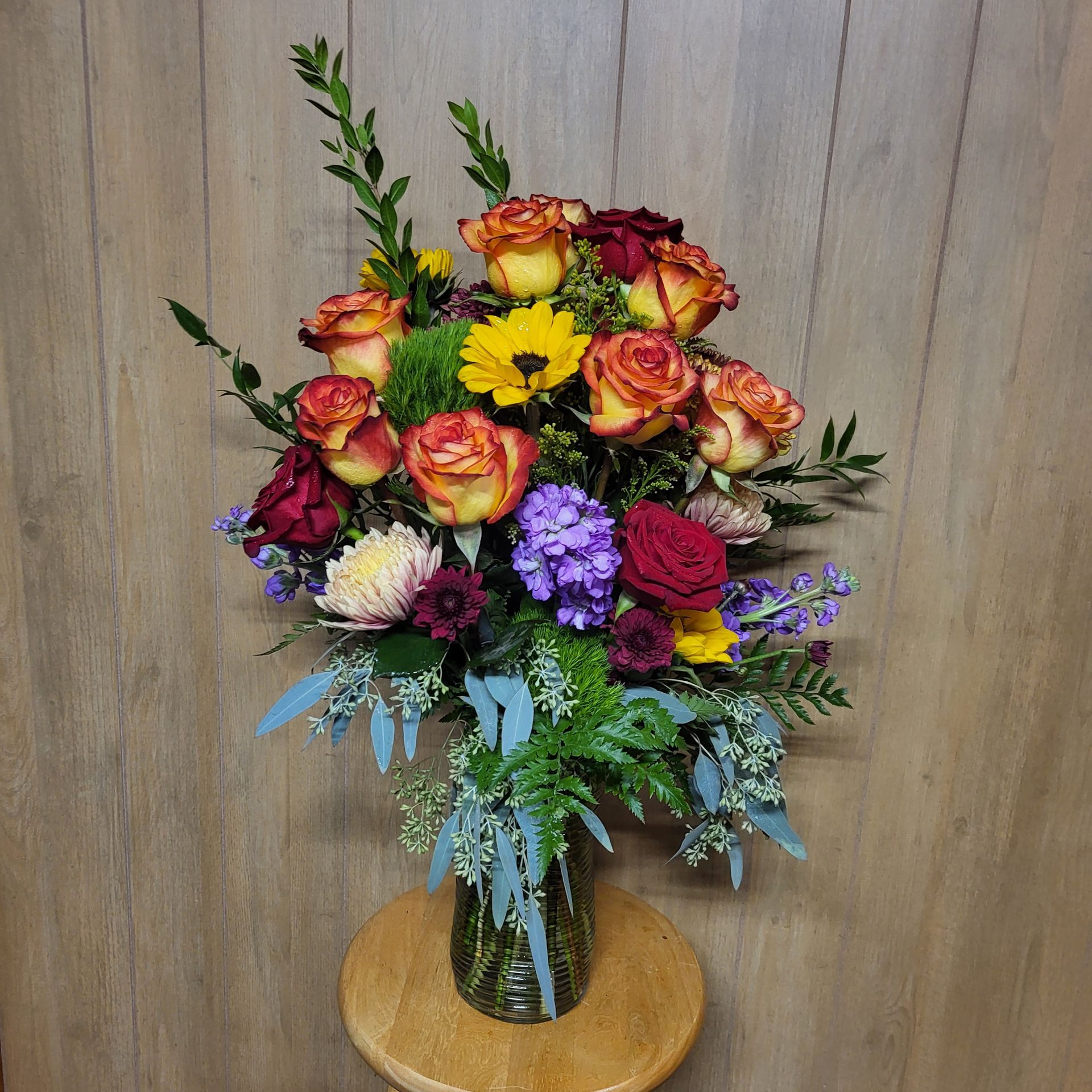A vase filled with flowers is sitting on a table.