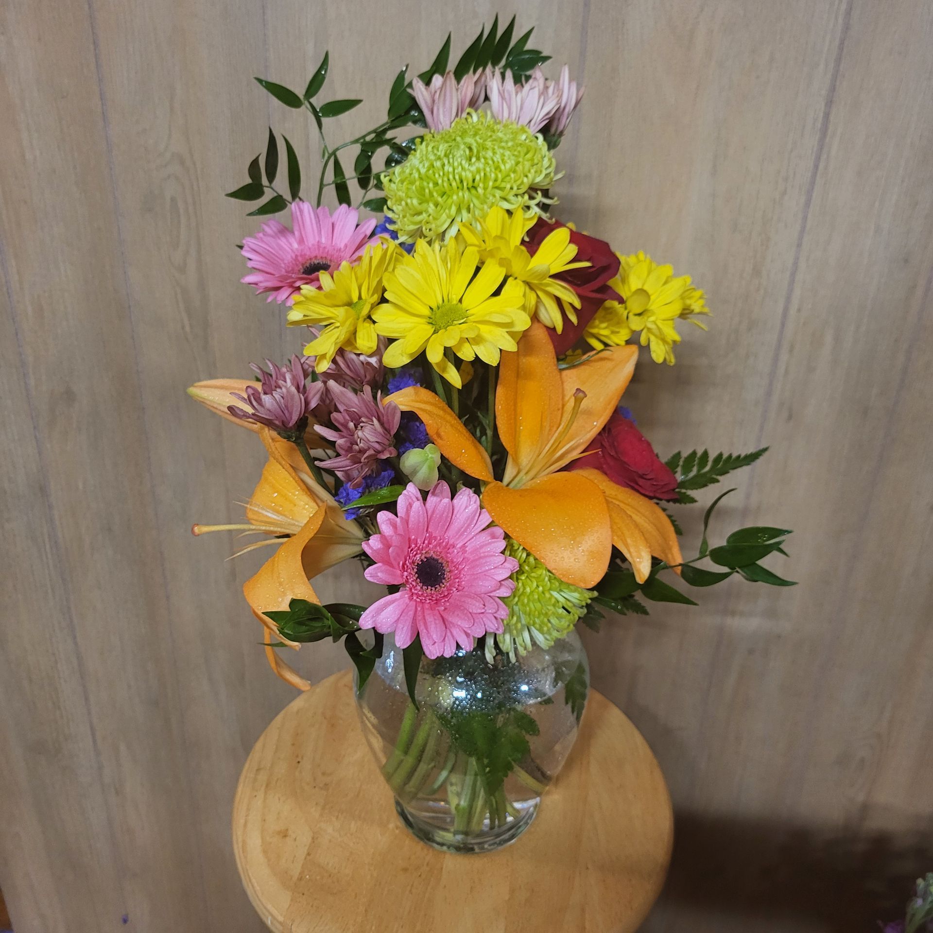 A vase filled with flowers is sitting on a table.
