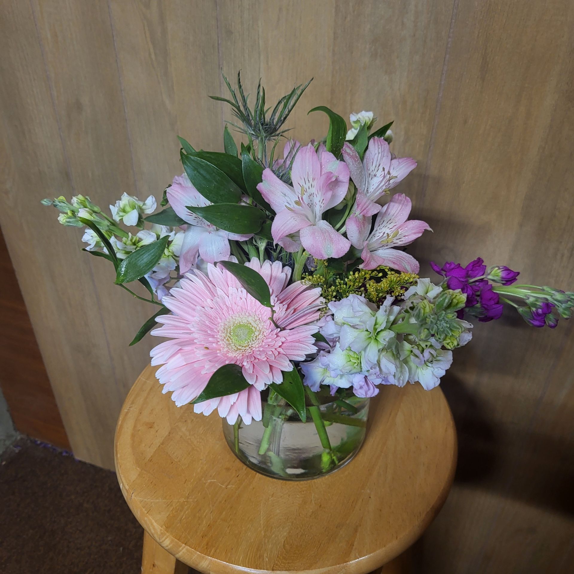 A vase filled with flowers is sitting on a table.