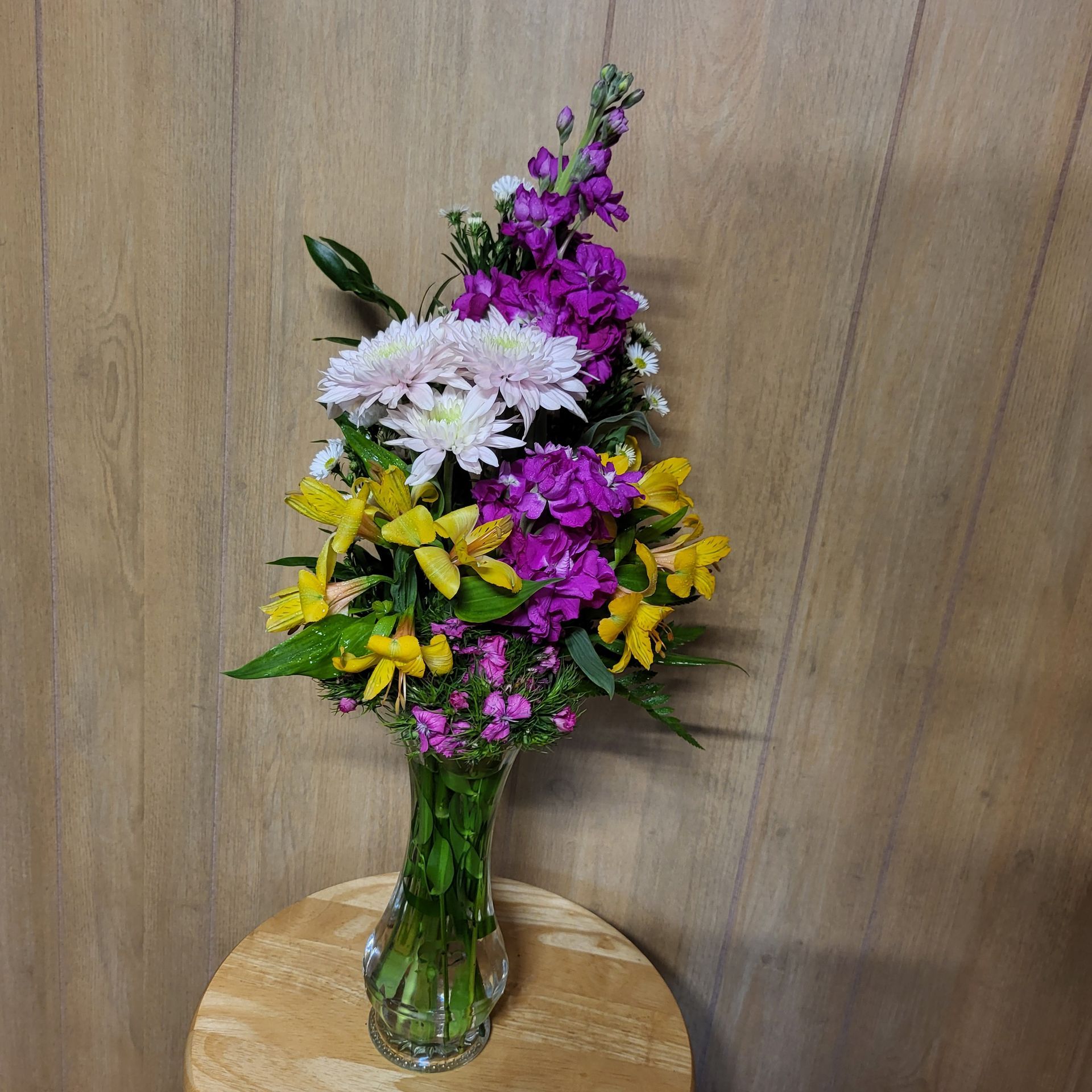 A vase filled with flowers is sitting on a table.