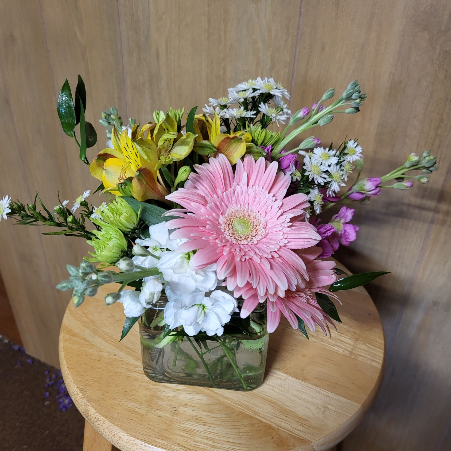 A vase filled with flowers is sitting on a table.