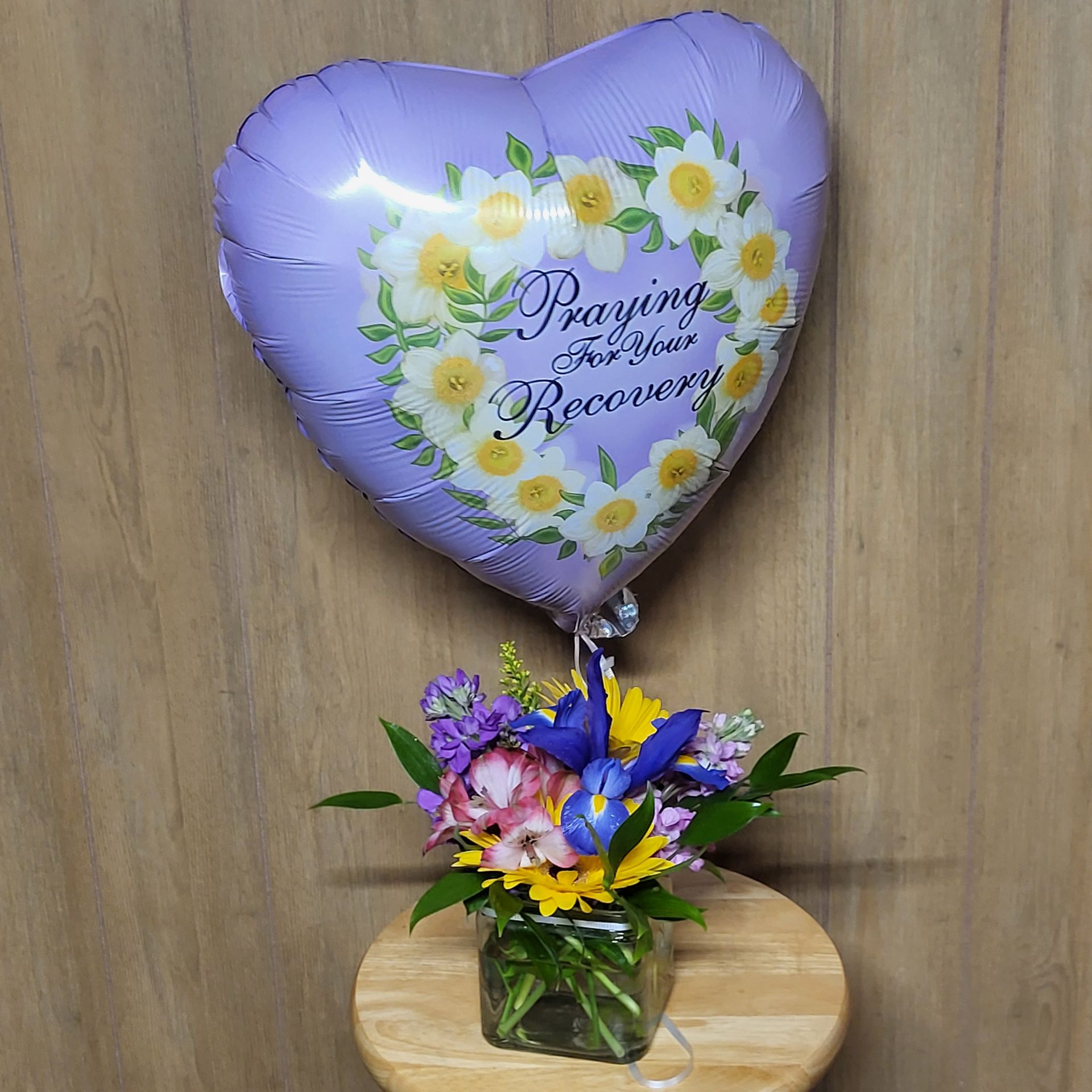 A vase filled with flowers is sitting on a table.