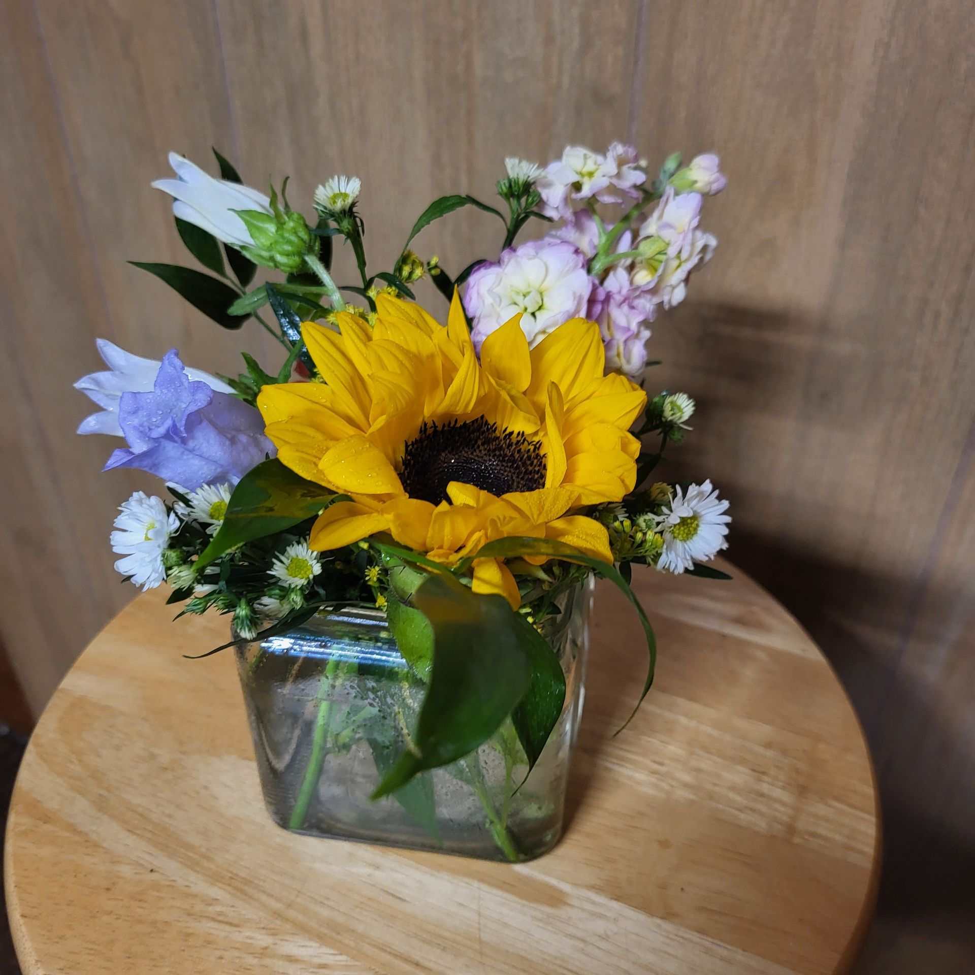 A vase filled with flowers is sitting on a table.