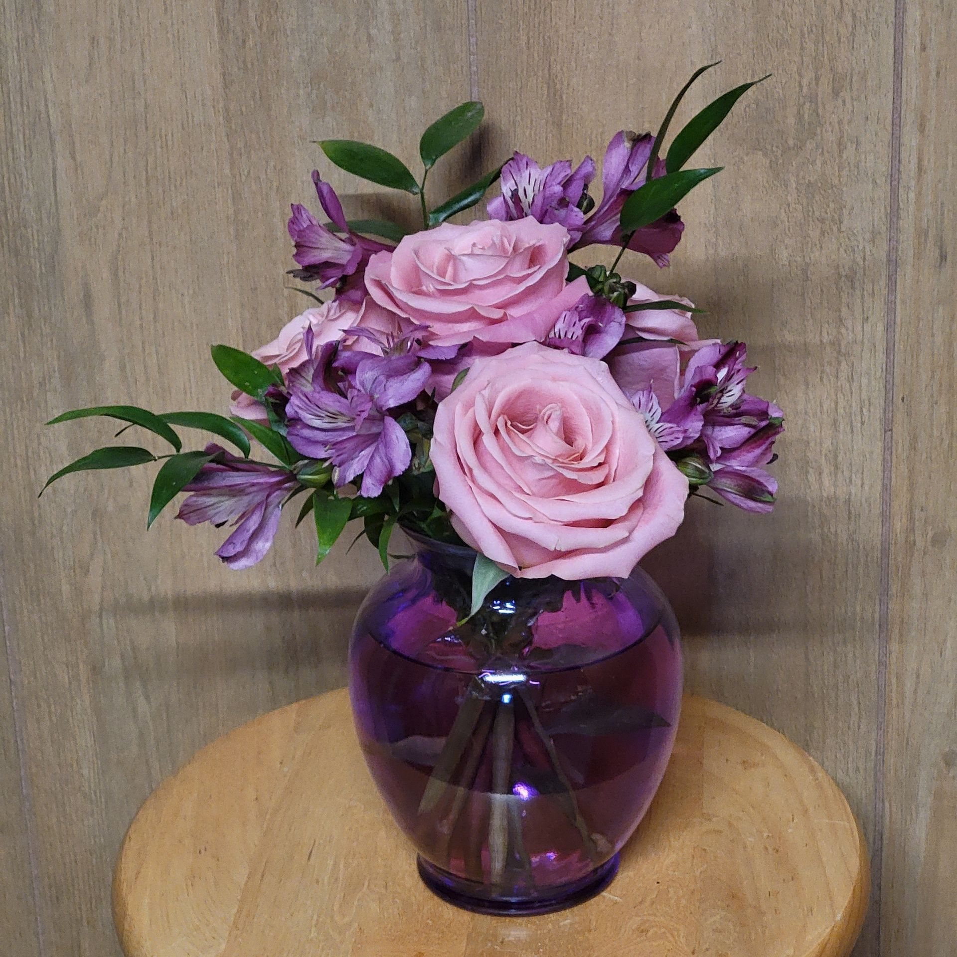 A vase filled with flowers is sitting on a table.