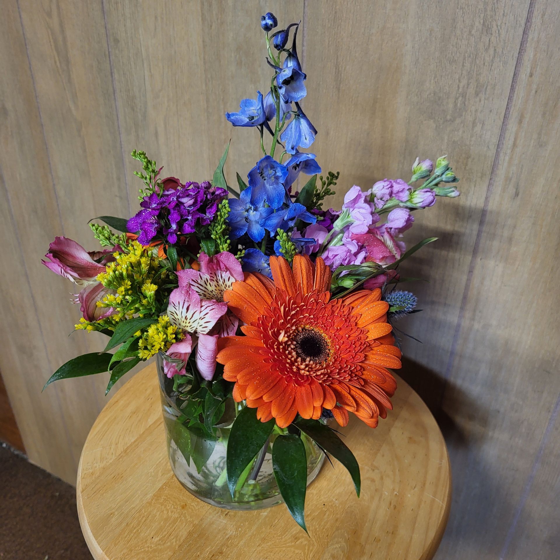 A vase filled with flowers is sitting on a table.