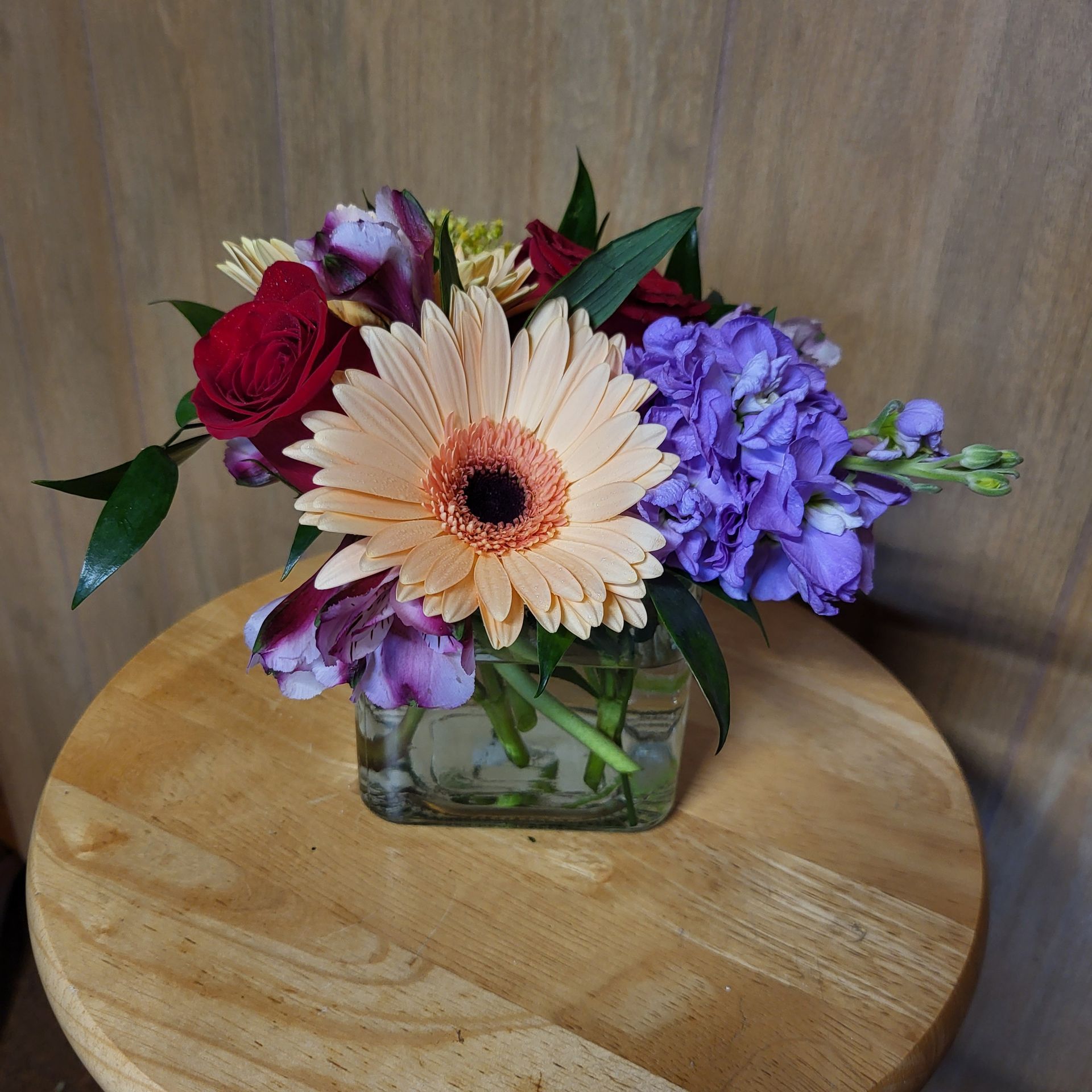 A vase filled with flowers is sitting on a table.