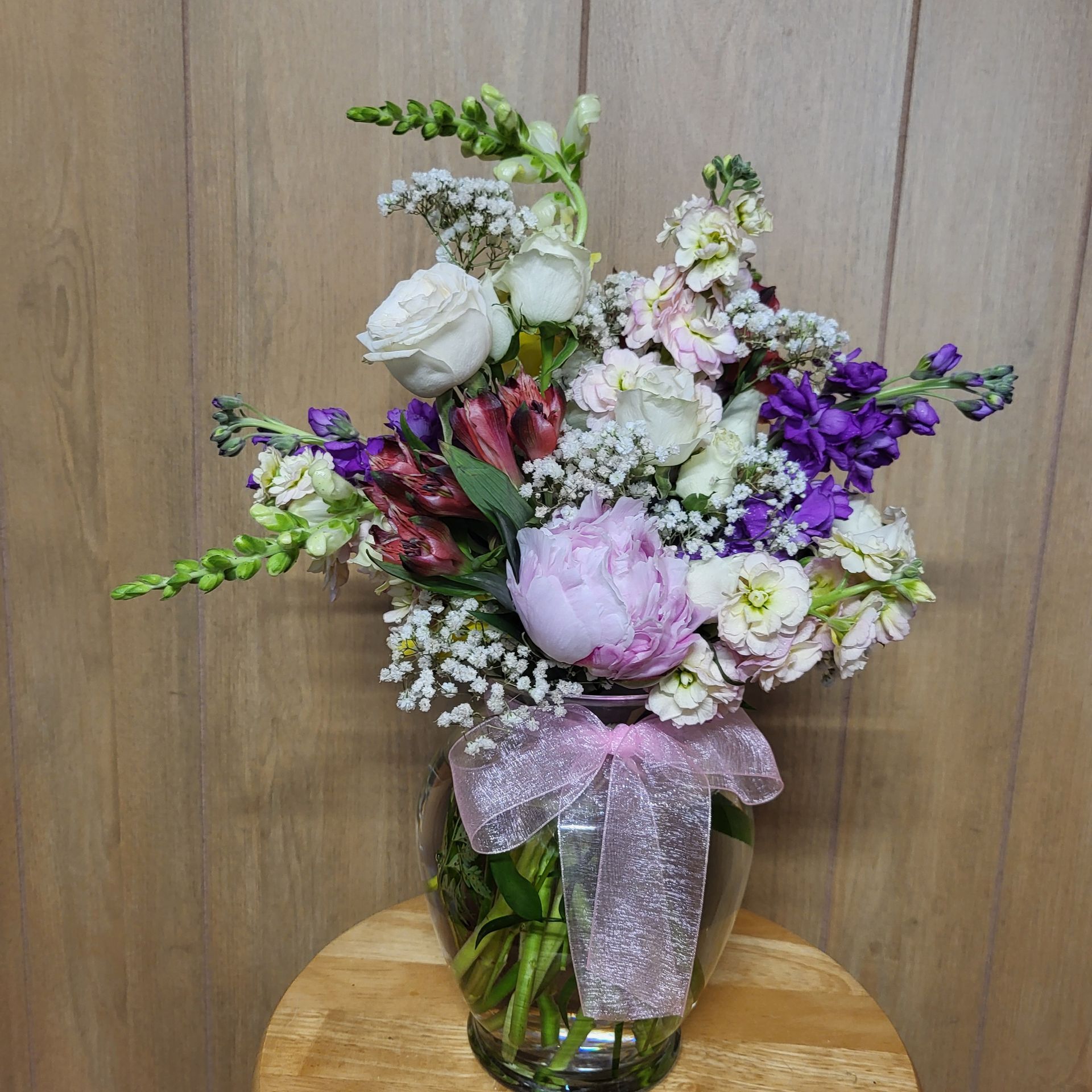 A vase filled with flowers is sitting on a table.
