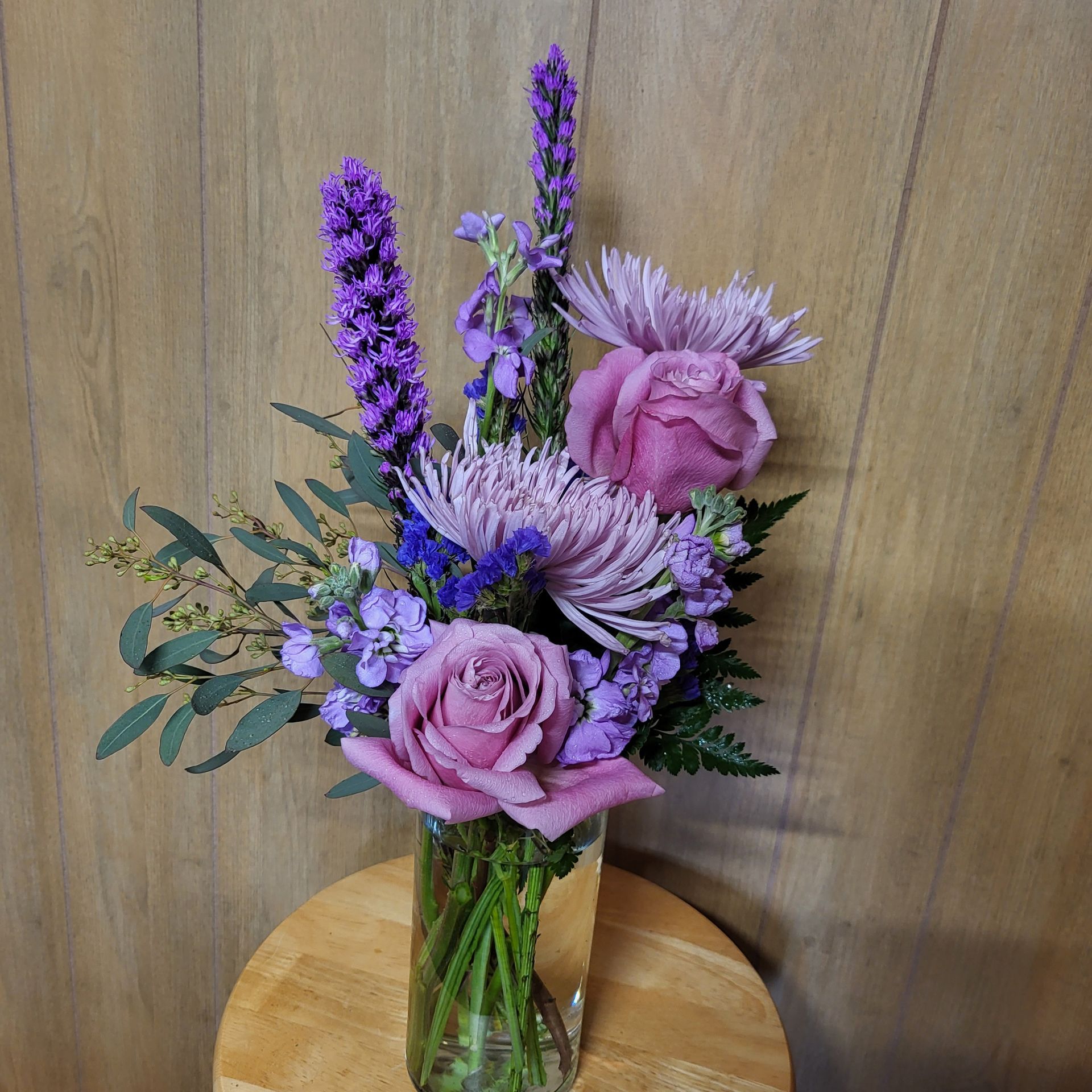 A vase filled with flowers is sitting on a table.