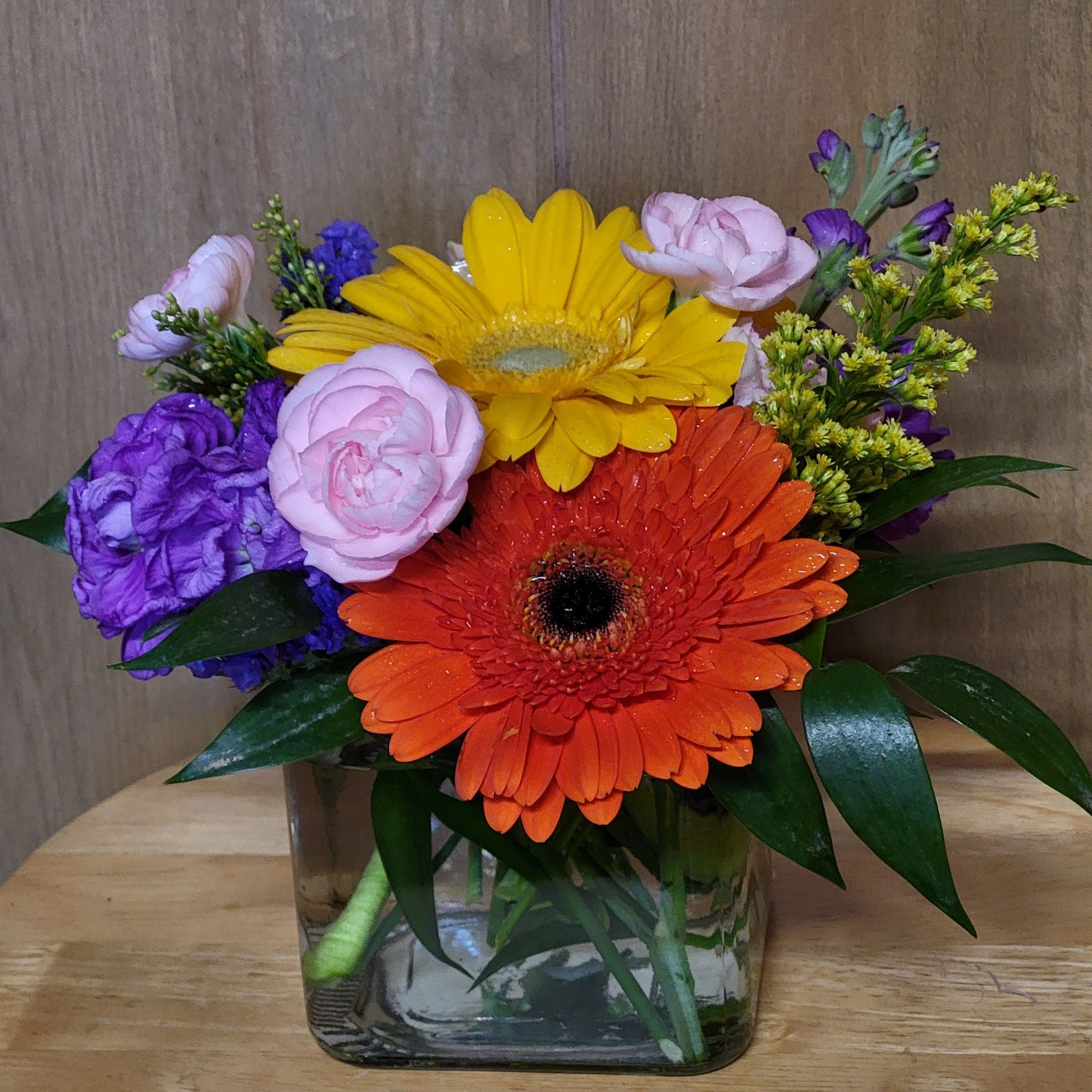 A vase filled with flowers is sitting on a table.