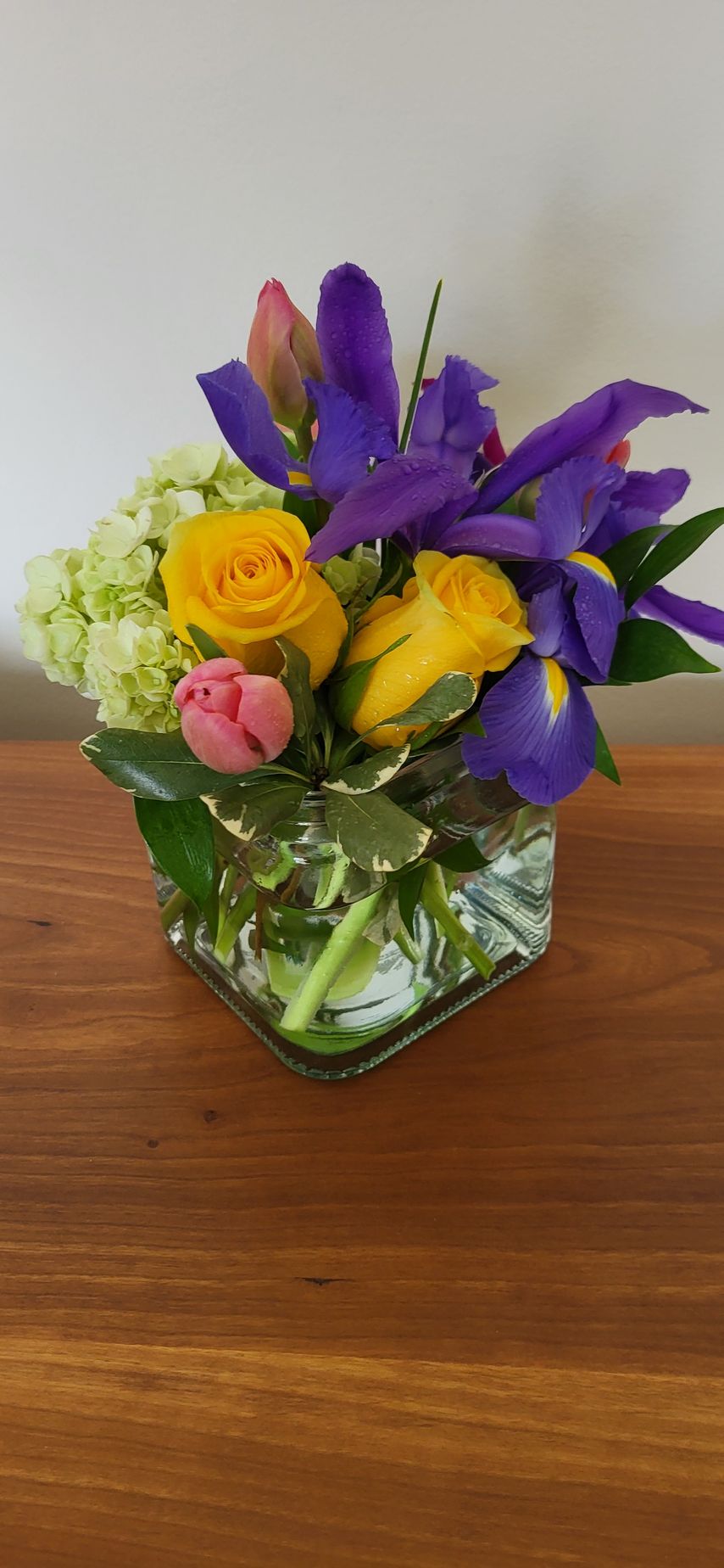 A vase filled with flowers is sitting on a table.