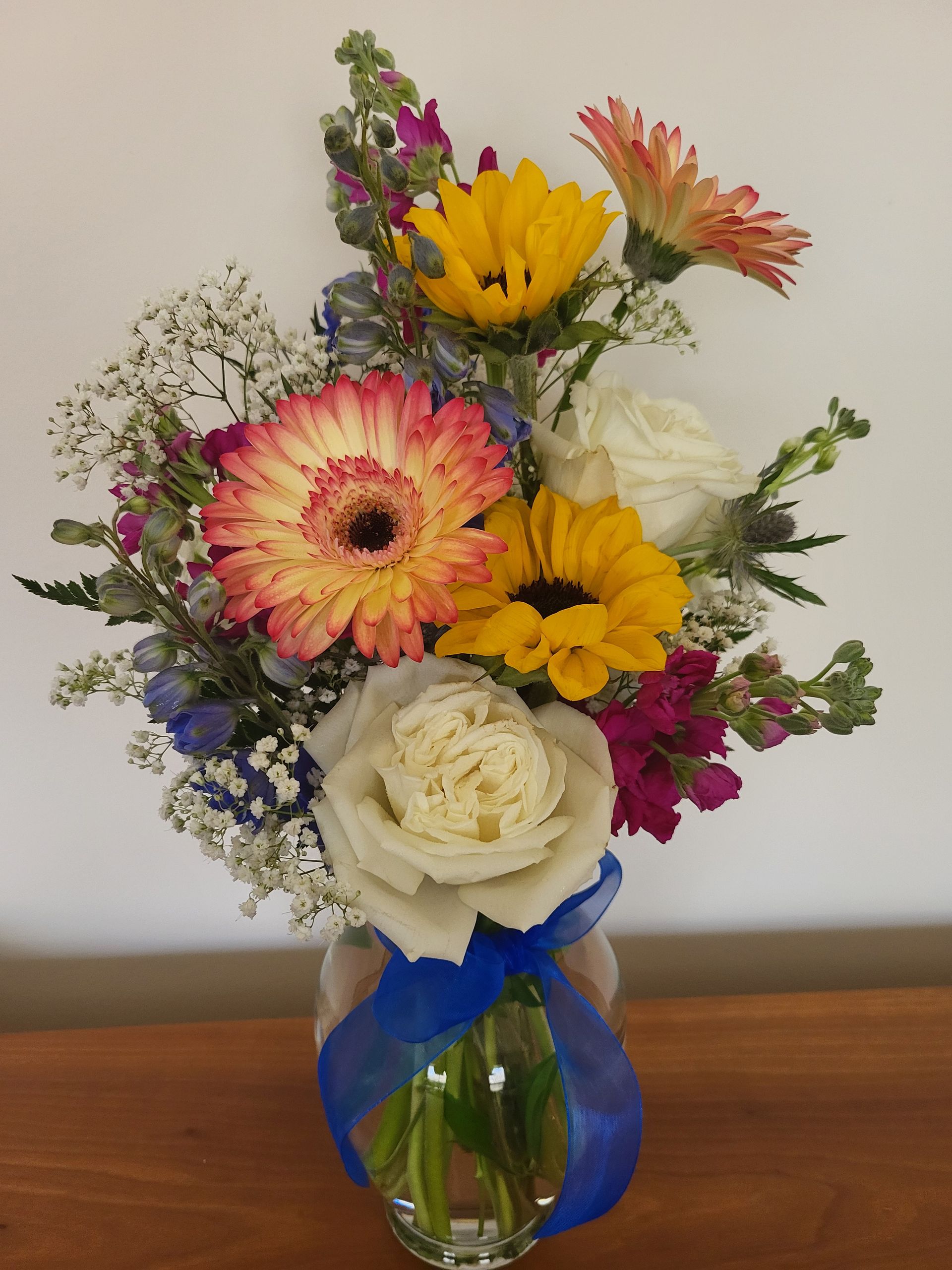 A vase filled with flowers is sitting on a table.