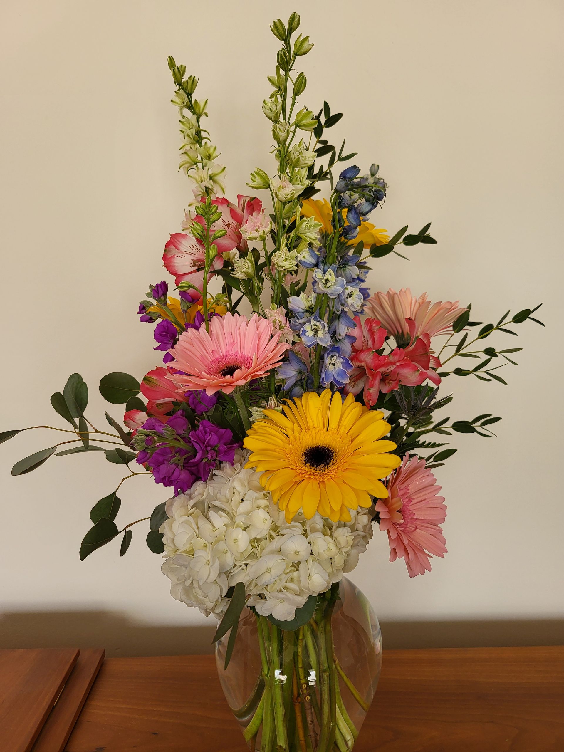 A vase filled with flowers is sitting on a table.