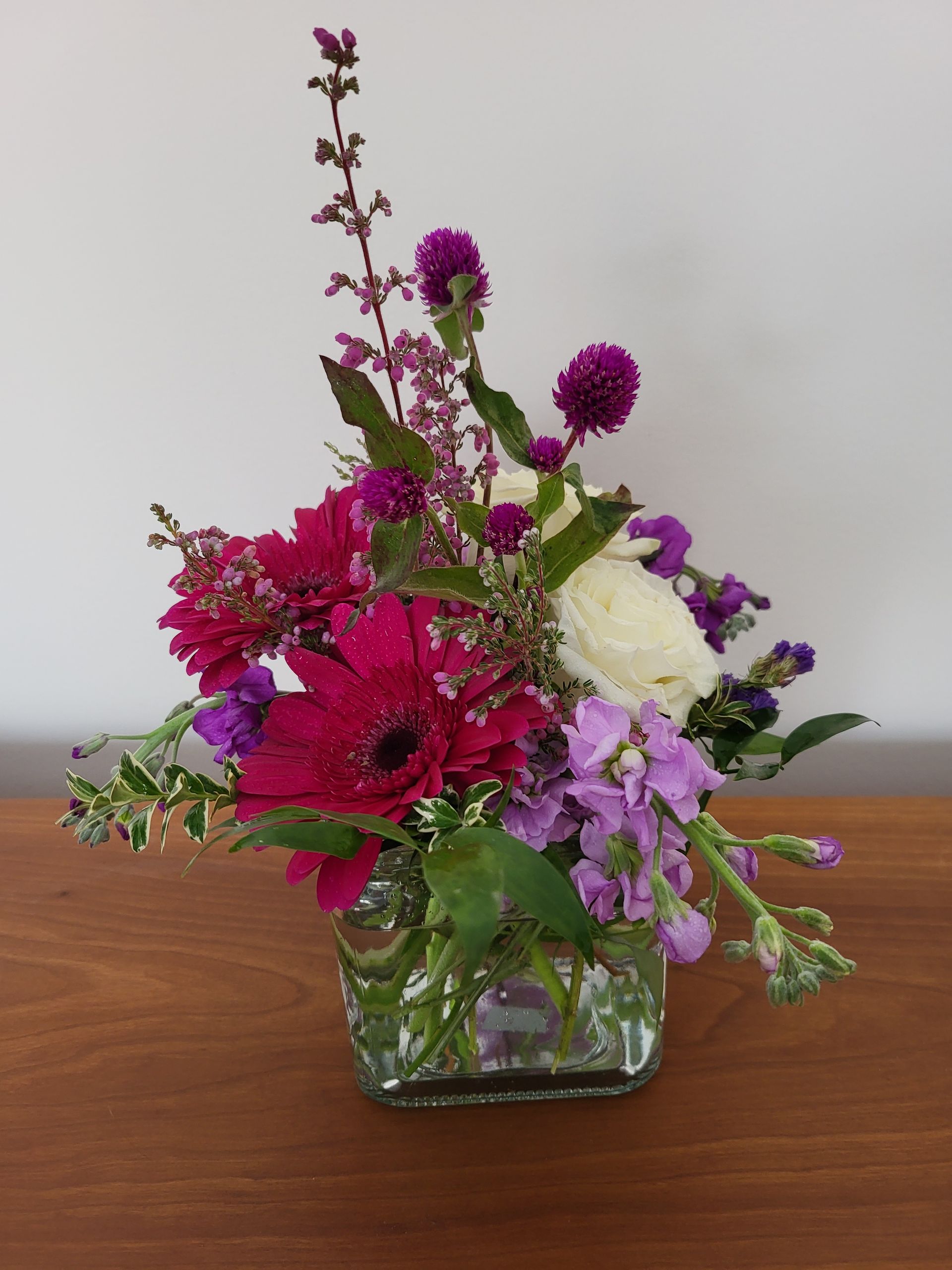 A vase filled with flowers is sitting on a table.