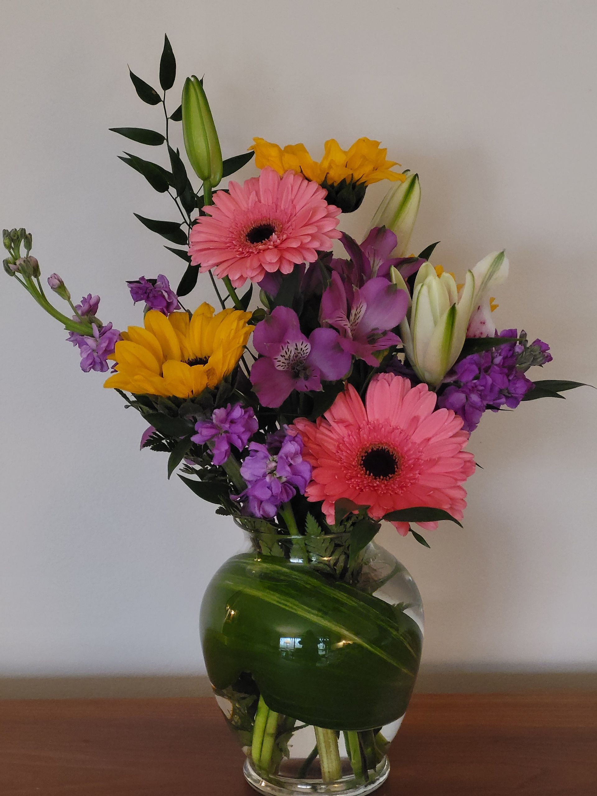 A vase filled with flowers is sitting on a table.