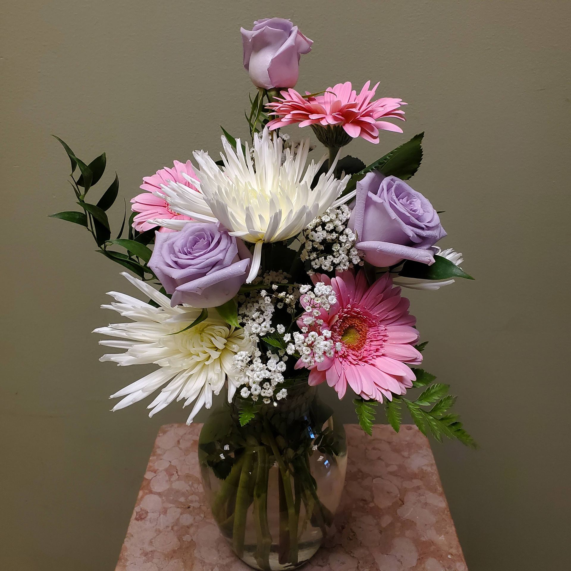 A vase filled with flowers is sitting on a table.